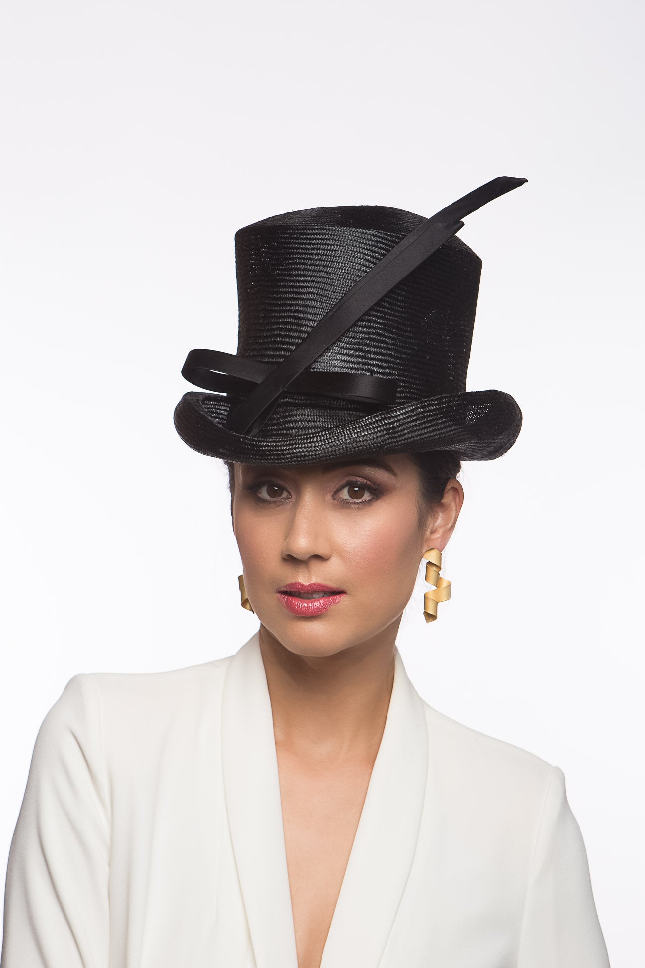 The Classic Black Top Hat features a curved top hat, trimmed with lux silk satin bow