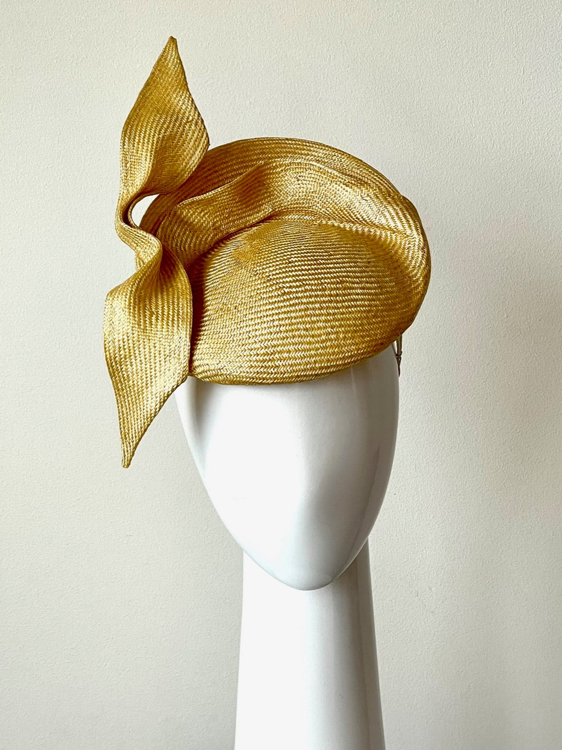 The Golden Yellow Sculptured Raised Beret features an extremely comfortable beret base. Trimmed with hand sculptured twists and folds within and around the beret