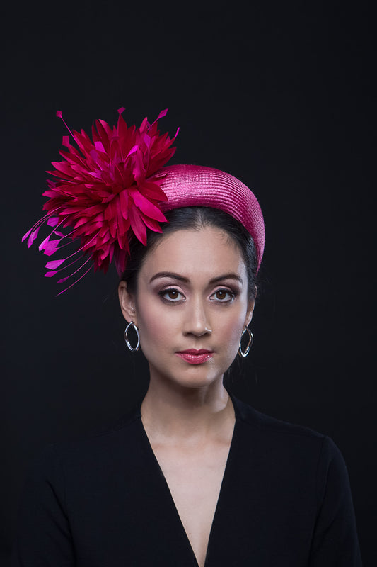The Hot Pink Chrysanthemum Halo Headband is a raised straw headband with pom pom chrysanthemums.