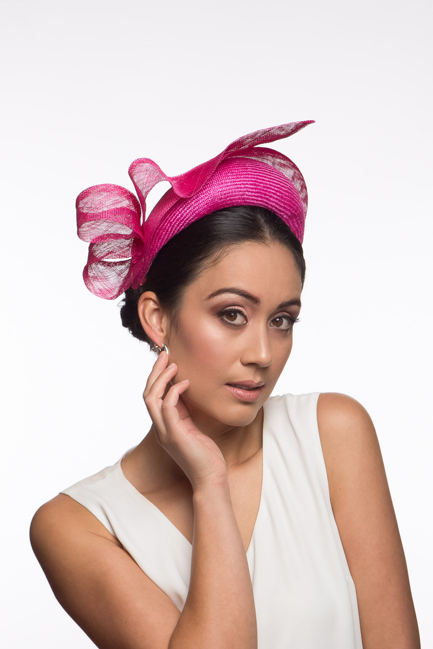The Hot Pink Halo Headband with Floating Bow features a parisisal straw headband trimmed with a sinamay edge and a gorgeous floating bow which adds lightness and height