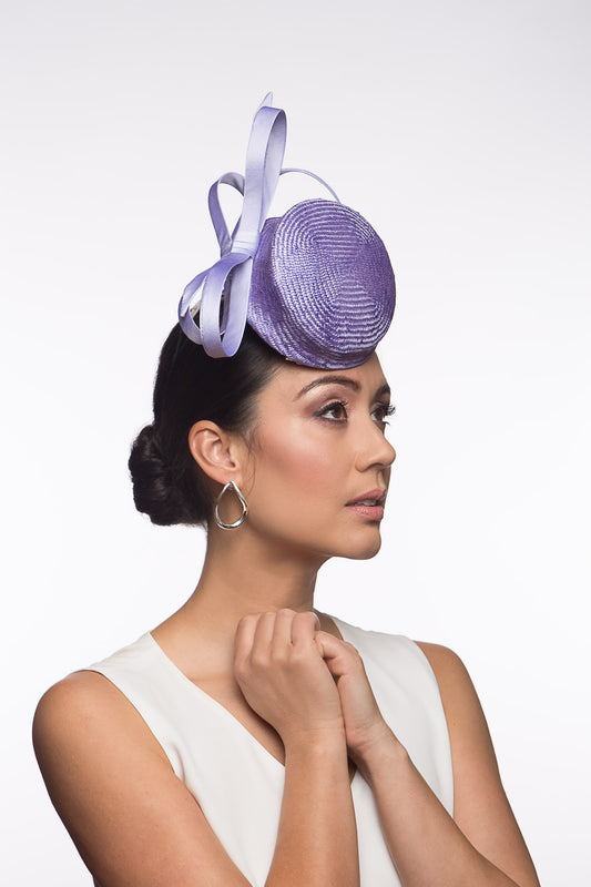 The Lilac Button Percher Hat features a raised button hat trimmed with silk satin stylised double bows which look beautiful from every angl