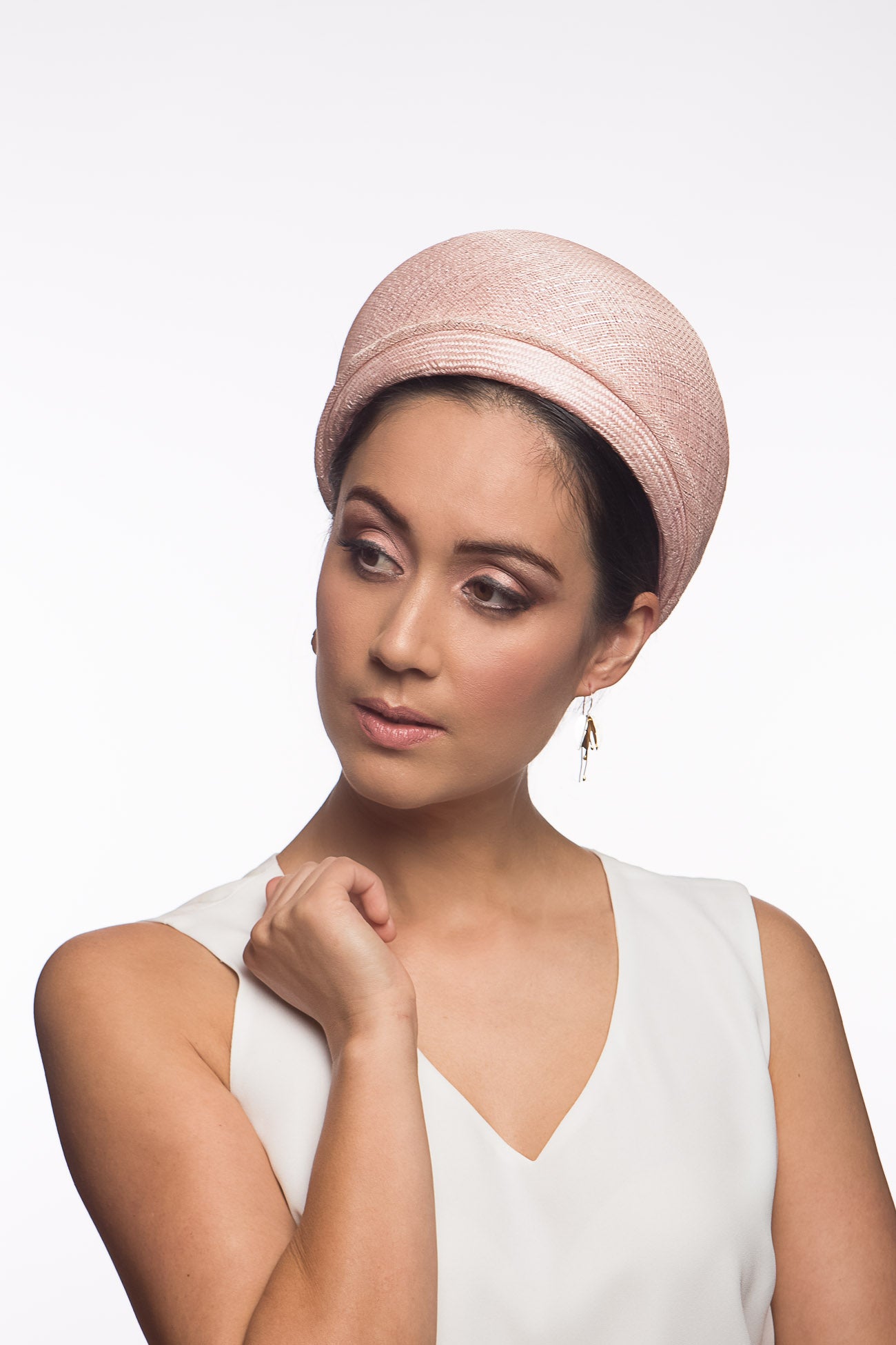 The Raised Pale Pink Halo Headband features a parisisal straw headband overlayed with a pale pink and silver flecked sinamay which adds lightness and height