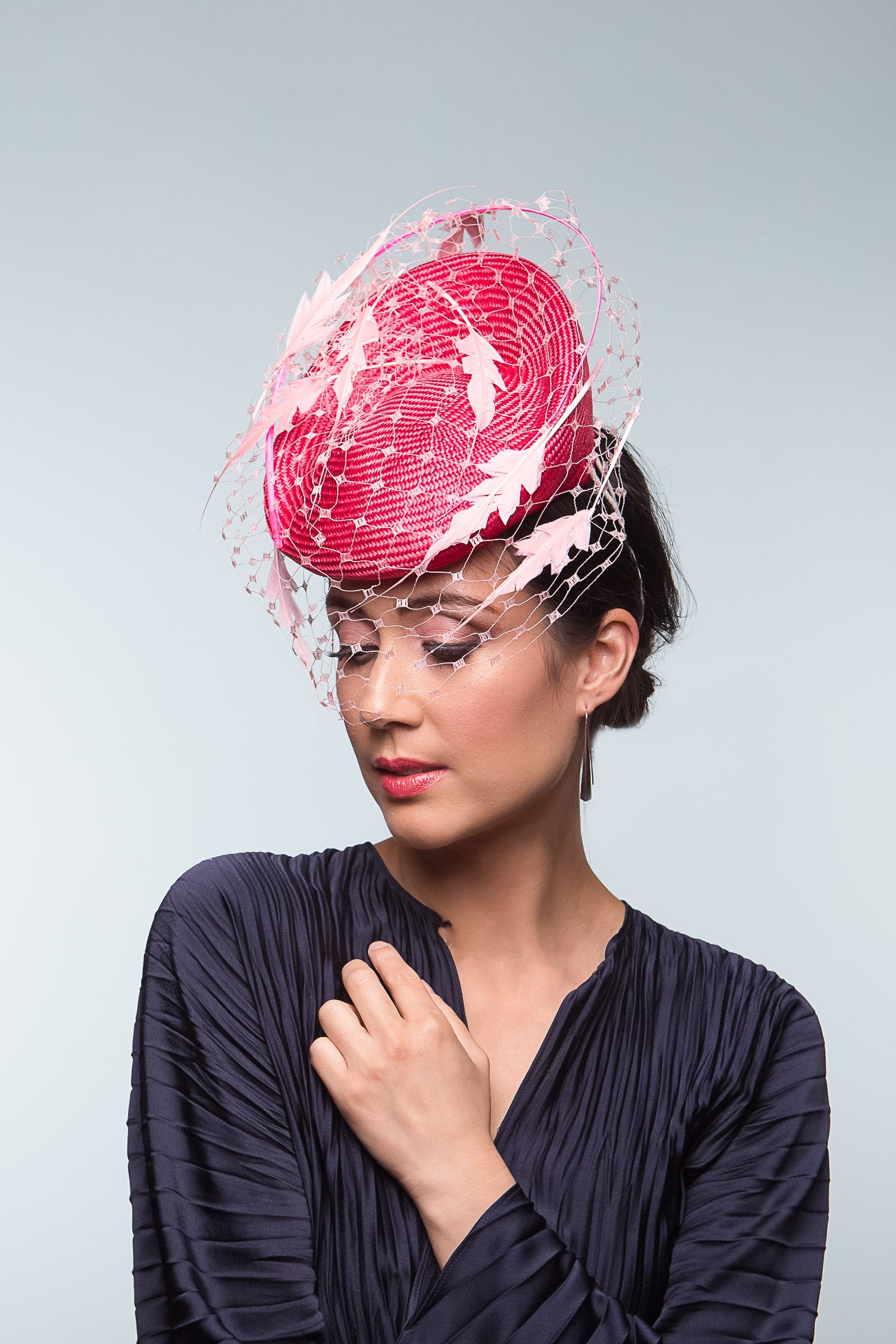 The Two-Toned Pink Raised Beret with Floating Feathers is an extremely comfortable beret base, trimmed with curved quills floating feathered leaves and a , fine vintage veiling.