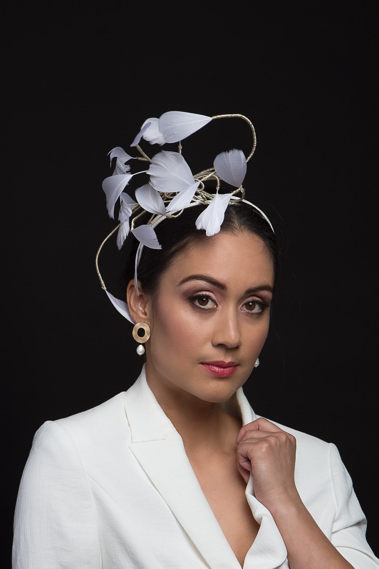 White Floating Feather Headpiece by Felicity Northeast Millinery is a gorgeous headband with cascading white feathers and light gold highlights.