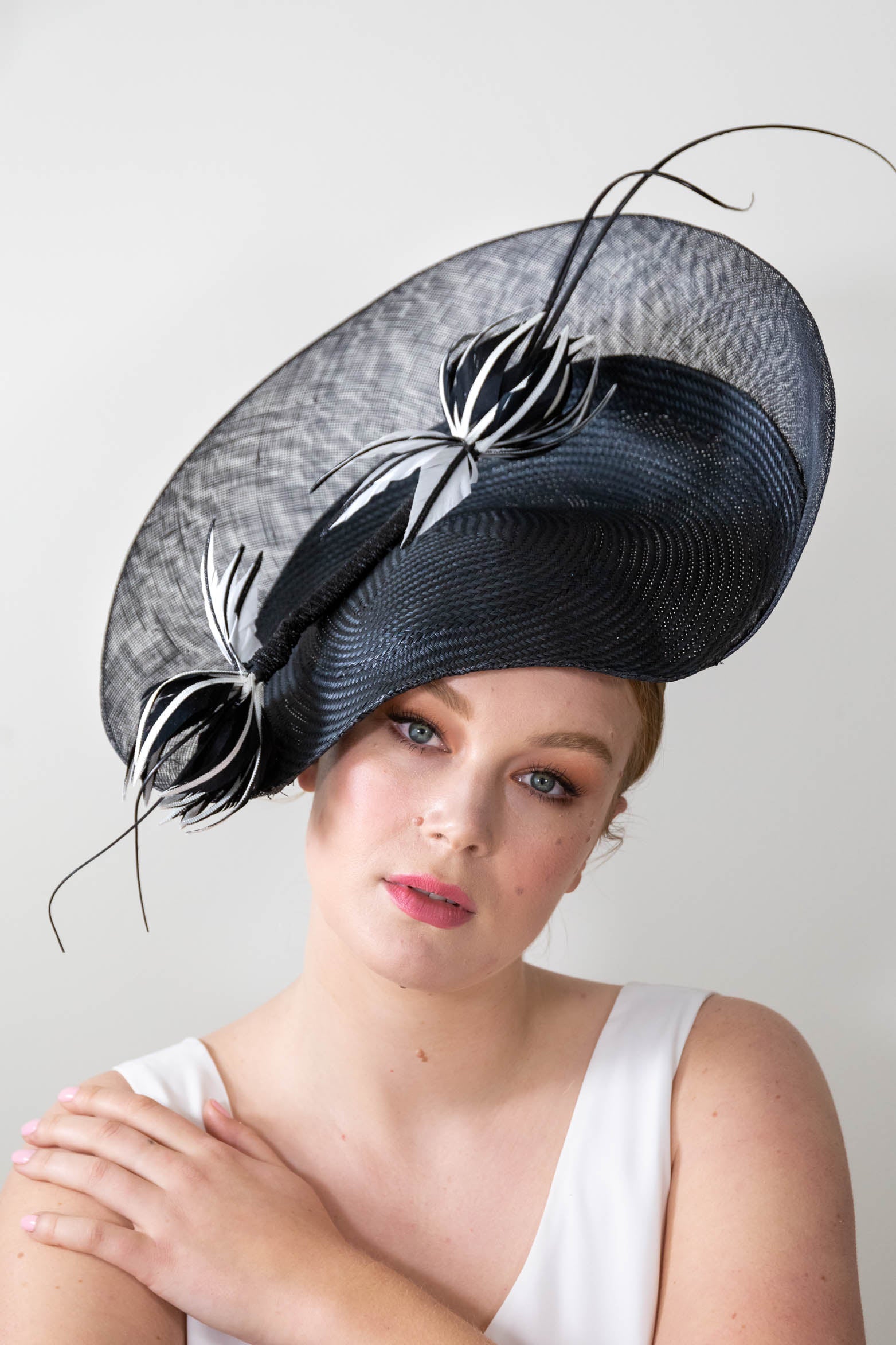 Sweeping black platter with feather flowers by Felicity Northeast Millinery