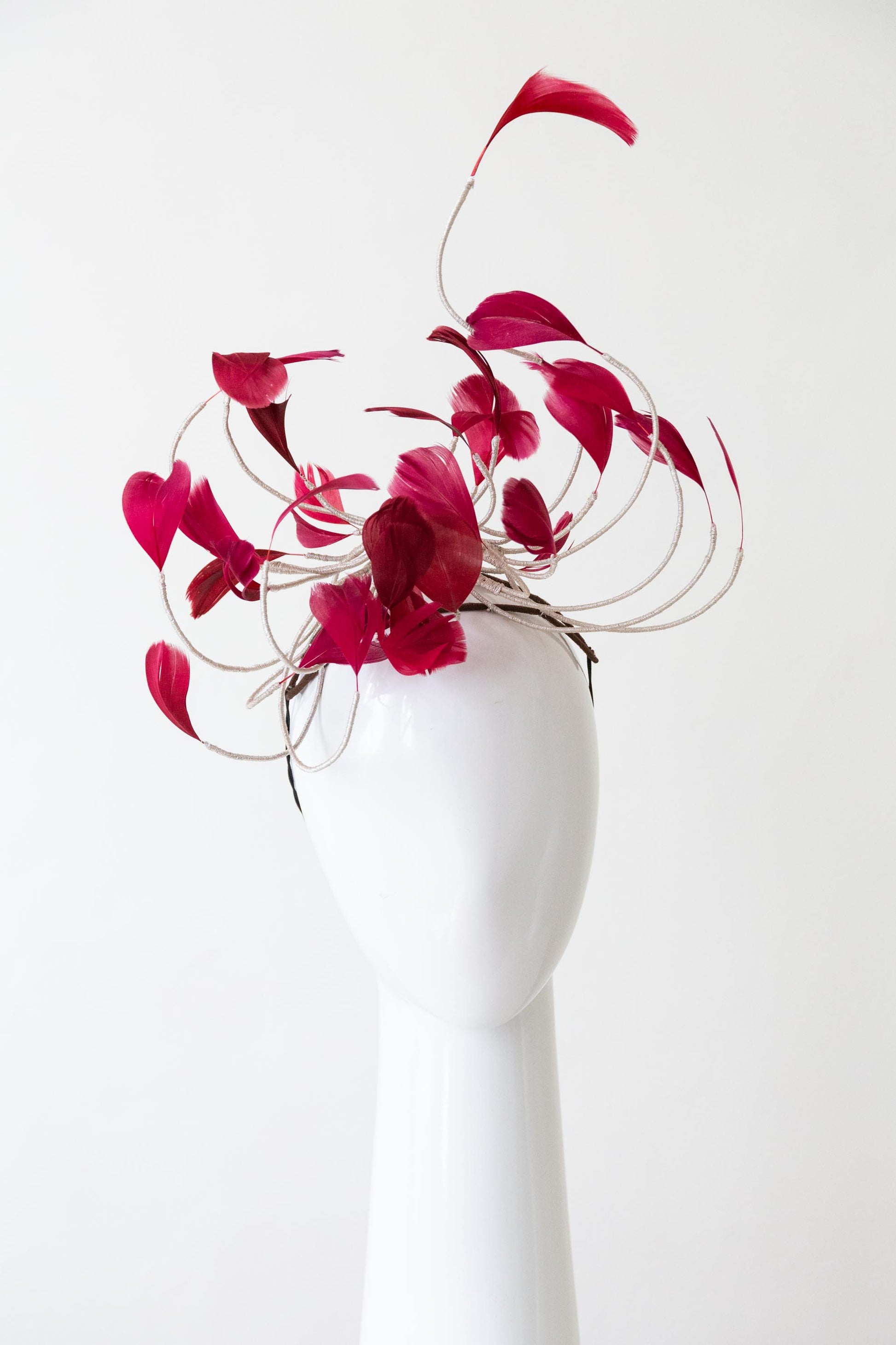 The Burgundy Floating Feather Swirl Flower is a cascade of floating feathers and silver highlight