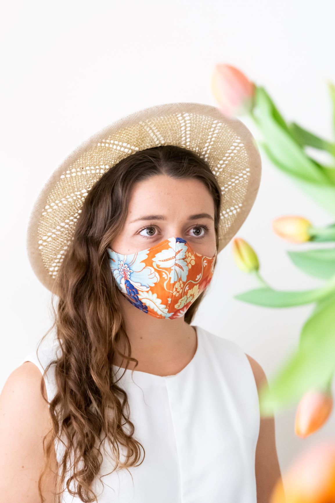 Open weave natural and cream boater worn with face mask by felicity Northeast Millinery