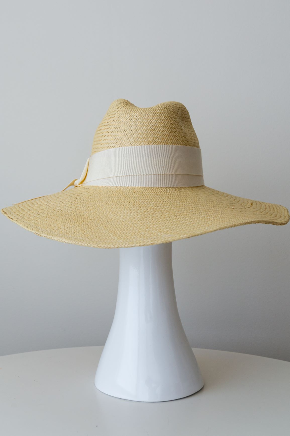 Natural panama fedora with soft brim and wide cream grosgrain ribbon