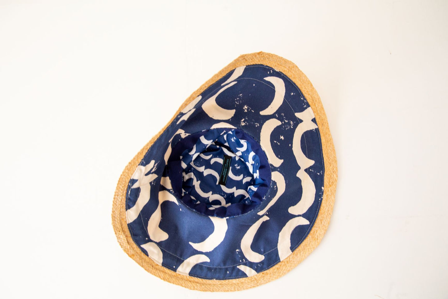 Wide brimmed raffia and blue canvas sunhat inside
