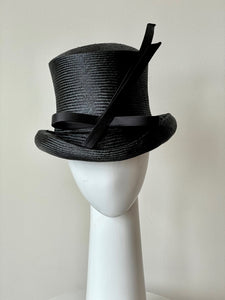 The Classic Black Top Hat features a curved top hat, trimmed with lux silk satin bow