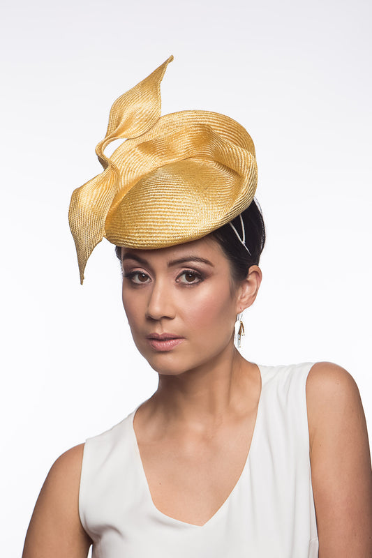 The Golden Yellow Sculptured Raised Beret features an extremely comfortable beret base. Trimmed with hand sculptured twists and folds within and around the beret