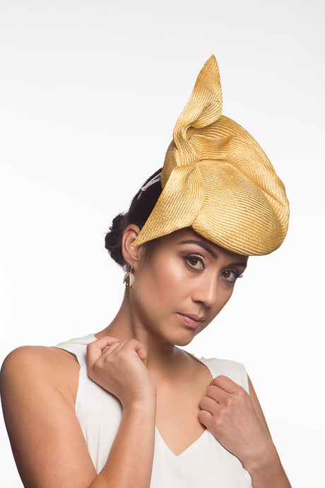 The Golden Yellow Sculptured Raised Beret features an extremely comfortable beret base. Trimmed with hand sculptured twists and folds within and around the beret