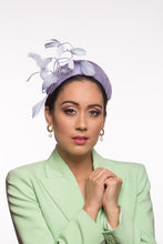Load image into Gallery viewer, The headband is hand blocked in parisisal straw, trimmed with shaped dancing feathers feathers in lilac,purple and mauve.