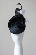 Load image into Gallery viewer, The Black and White Swirl Beret Platter Hat is a, raised button beret in black straw and trimmed with a white floating bow