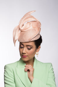 The Pink Double Curl Raised Beret features a straw pleated swirl that curves over the beret.