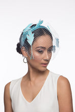 Load image into Gallery viewer, The Veiled Feather Leaf Headband in Blues features a birdcage veil adorned with feather leaves. The sky blue feather leaves are arranged over the pale blue ones