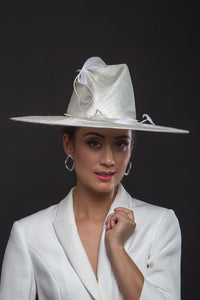 The Cream Fedora with Sweeping Bow is a modern fedora with a high angular concave crown and a sweeping wide brim