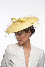 Load image into Gallery viewer, The Yellow Platter Hat with Bow and Veiling features a wide Dior brim with a shallow crown. Trimmed with a lux satin silk bow on across the brim and draped in a fine vintage veiling