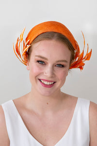 Orange bandeau with sweeping back feathers by Felicity Northeast Millinery