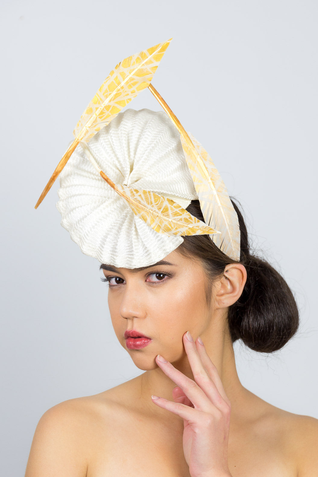 GEORGIA- a pleated straw headpiece with gold artisan feathers		